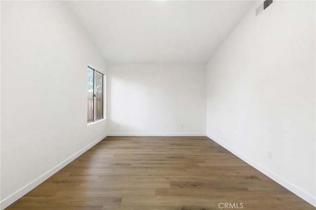 2203 Scott Ave, Palmdale, CA 93550 - unfurnished room with dark wood-style floors, visible vents, and baseboards
