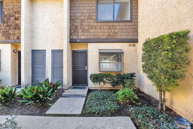 property entrance with stucco siding