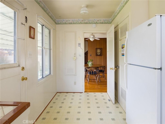 entryway with baseboards, plenty of natural light, and light floors