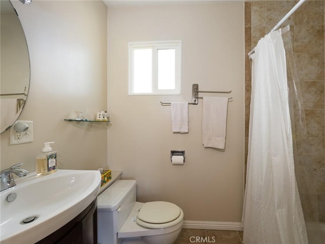 full bath featuring baseboards, tiled shower, toilet, tile patterned flooring, and vanity