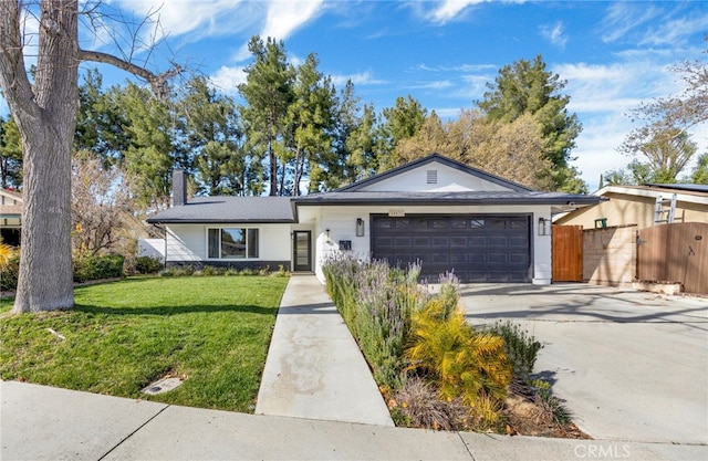 ranch-style house with a garage, fence, concrete driveway, a chimney, and a front yard