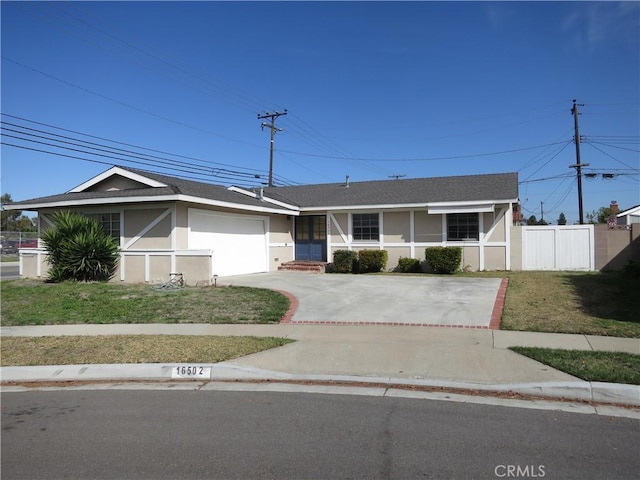 ranch-style house featuring concrete driveway, stucco siding, an attached garage, fence, and a front yard