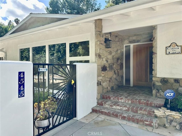 property entrance featuring stone siding