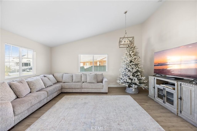 living room with high vaulted ceiling and light wood-type flooring