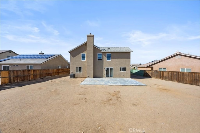 back of property with stucco siding, a patio, central AC unit, and a fenced backyard