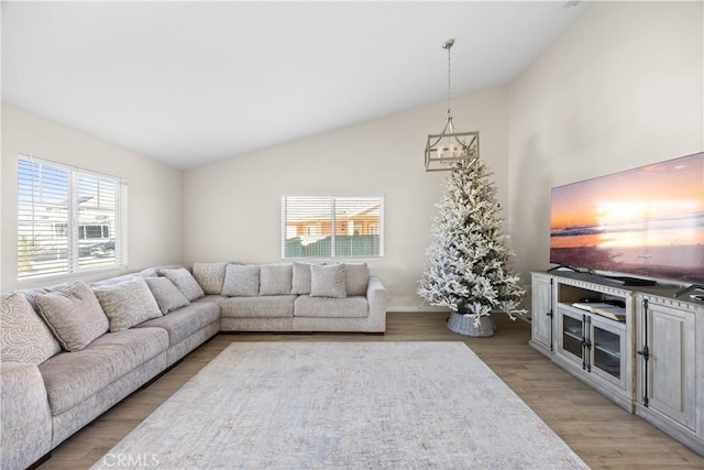 living area featuring high vaulted ceiling and light wood-type flooring