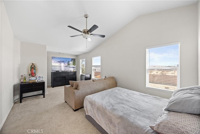 bedroom featuring light colored carpet, baseboards, lofted ceiling, and ceiling fan