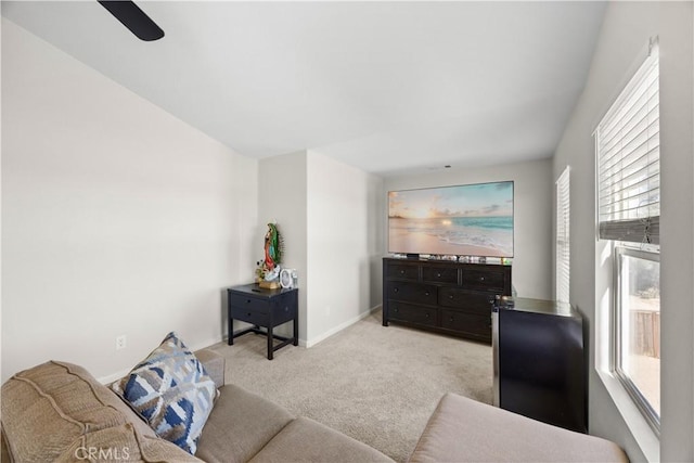 living room featuring light colored carpet and baseboards