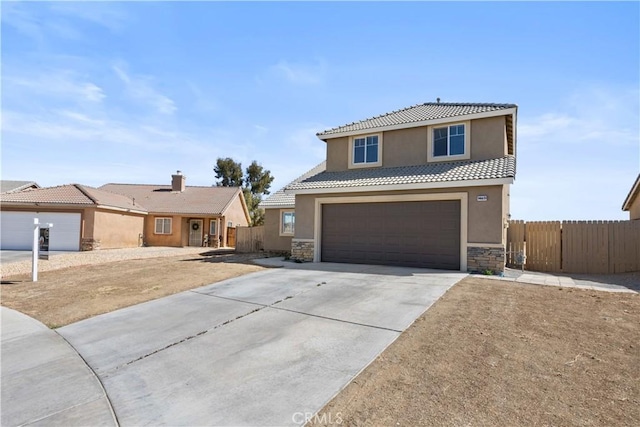 view of front facade with stucco siding, stone siding, fence, concrete driveway, and a garage