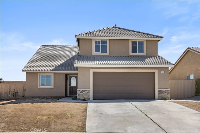 traditional home with a tiled roof, fence, stone siding, and driveway