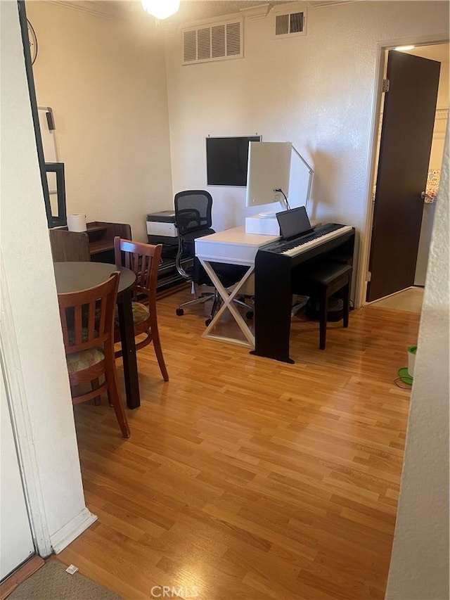 office with visible vents and light wood-style flooring