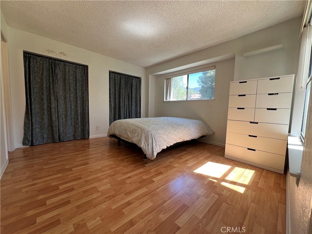 10655 Lemon Ave Unit 3808, Rancho Cucamonga, CA 91737 - bedroom featuring light wood finished floors, a textured ceiling, and baseboards