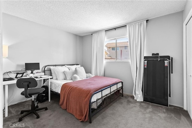 bedroom with a textured ceiling and light colored carpet