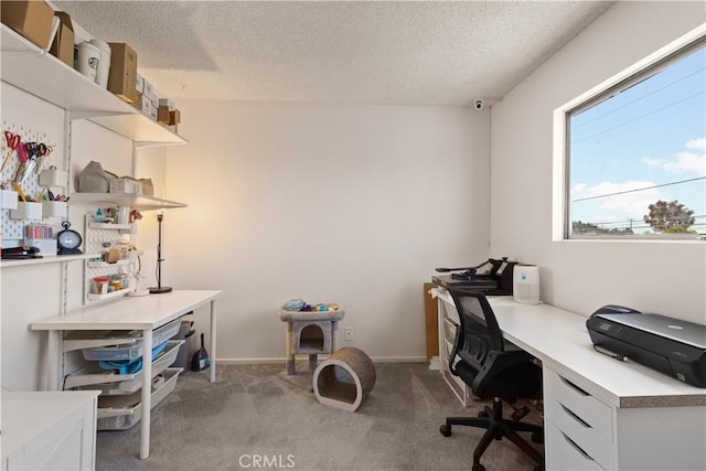 home office featuring light carpet, a textured ceiling, and baseboards