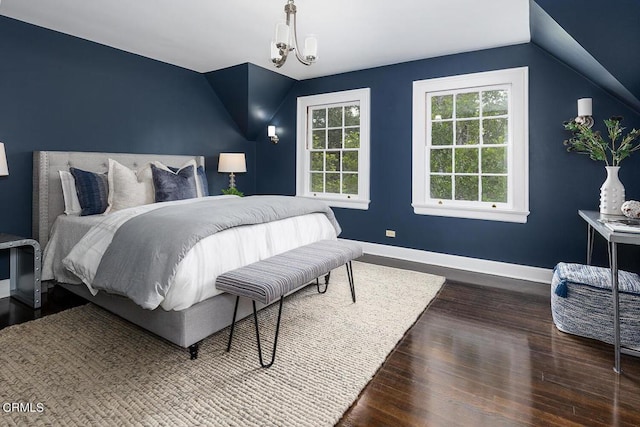 bedroom featuring vaulted ceiling, dark wood-style flooring, and baseboards