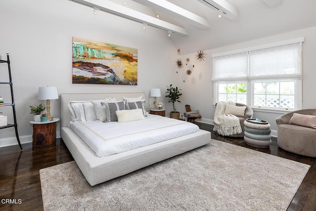 bedroom featuring dark wood-style flooring, rail lighting, beamed ceiling, and baseboards