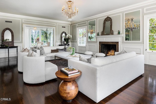 living room with an inviting chandelier, a wealth of natural light, and a decorative wall