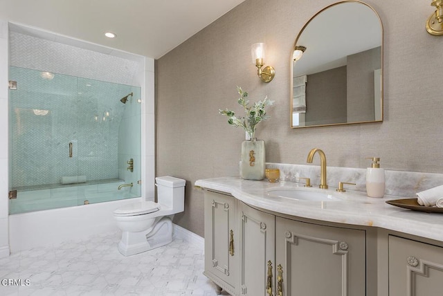 full bathroom featuring shower / bath combination with glass door, vanity, toilet, and baseboards