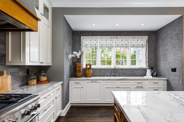 kitchen with glass insert cabinets, white cabinetry, and light stone counters