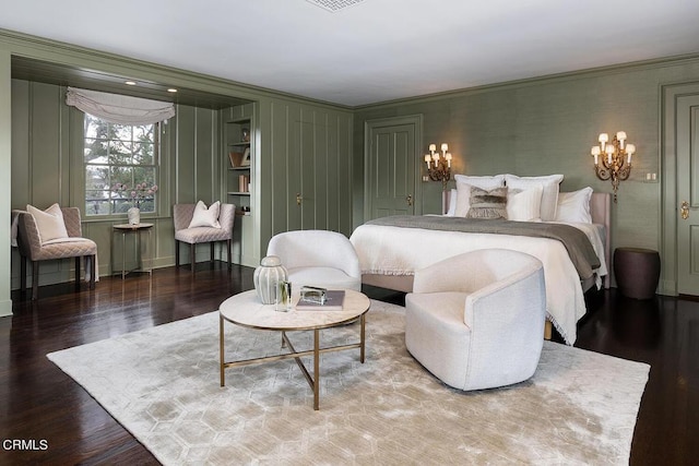 bedroom featuring visible vents, ornamental molding, and wood finished floors