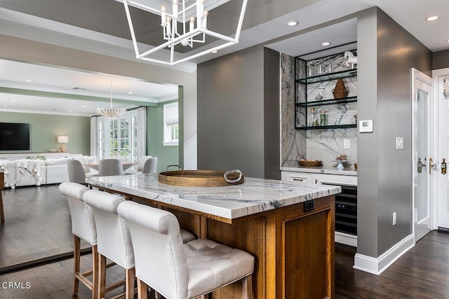 bar with a chandelier, dark wood-style flooring, ornamental molding, tasteful backsplash, and pendant lighting