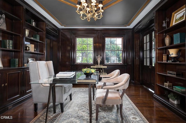 office featuring an inviting chandelier, wooden walls, dark wood finished floors, and crown molding