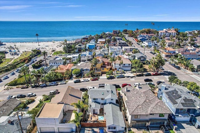 birds eye view of property with a beach view, a water view, and a residential view