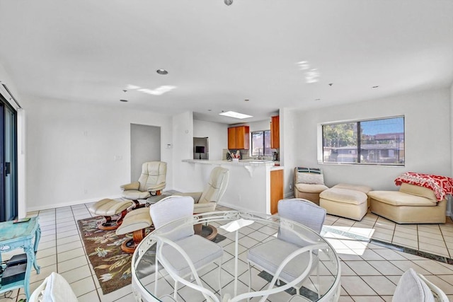 dining space featuring baseboards and light tile patterned floors