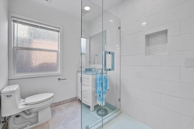 bathroom featuring toilet, a stall shower, and tile patterned floors