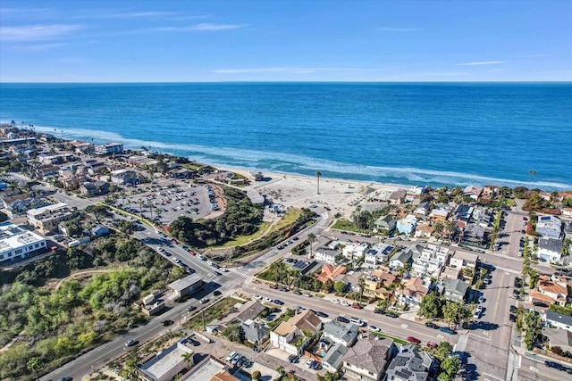 drone / aerial view with a water view and a beach view