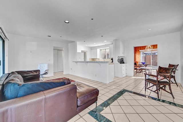 living area with recessed lighting and light tile patterned flooring