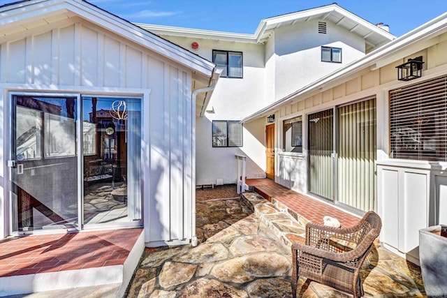 exterior space with board and batten siding and stucco siding