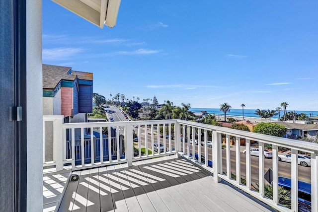 wooden terrace featuring a water view