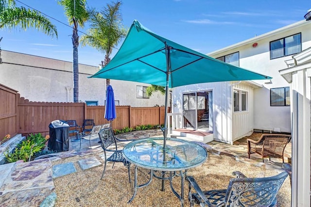 view of patio / terrace with outdoor dining space and a fenced backyard