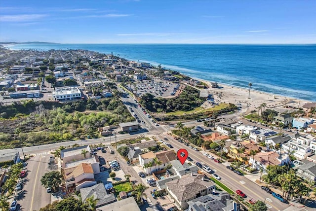 drone / aerial view with a residential view, a water view, and a beach view