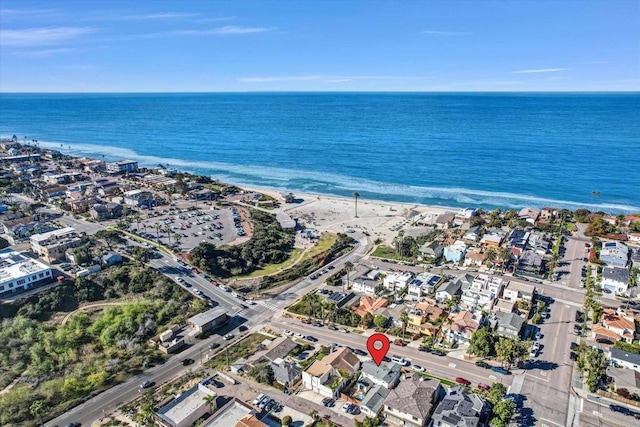 bird's eye view featuring a water view and a beach view