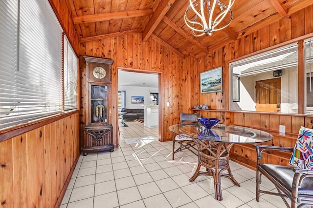 dining room with light tile patterned floors, wooden walls, wood ceiling, vaulted ceiling with beams, and an inviting chandelier