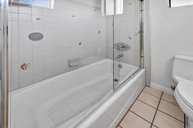 full bathroom with toilet, tile patterned flooring, baseboards, and combined bath / shower with glass door