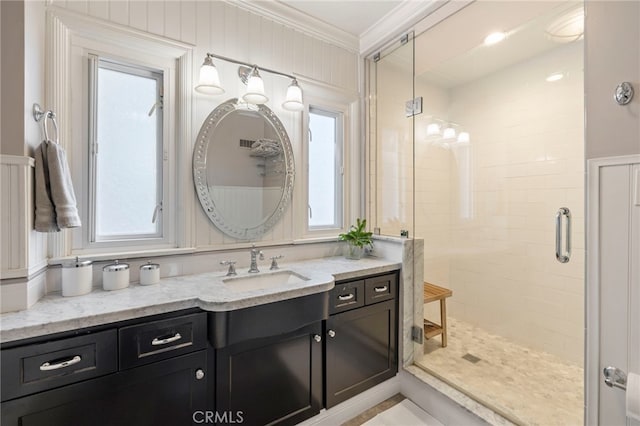 full bath featuring ornamental molding, a shower stall, and vanity