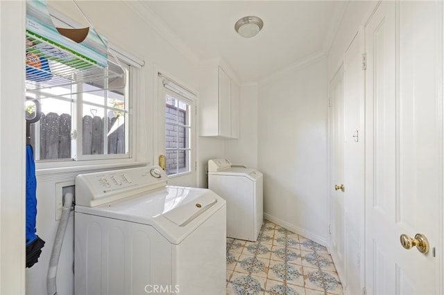 laundry area featuring crown molding, independent washer and dryer, and baseboards