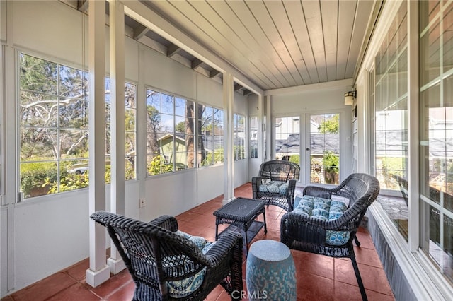 sunroom featuring a healthy amount of sunlight and wood ceiling