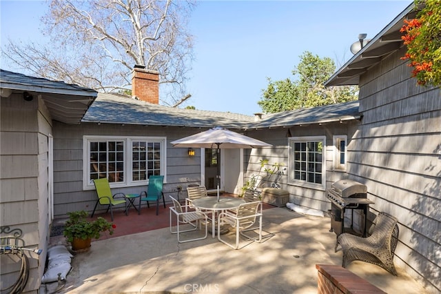 view of patio / terrace with outdoor dining space and a grill