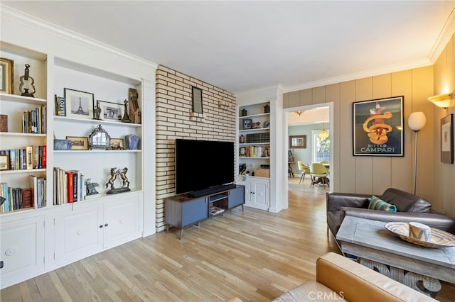 living area with light wood-type flooring, built in features, and crown molding