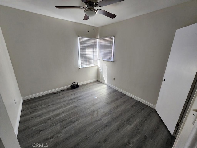 unfurnished bedroom with dark wood-style flooring, ceiling fan, and baseboards