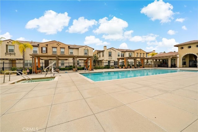 pool featuring a residential view, fence, a pergola, and a patio