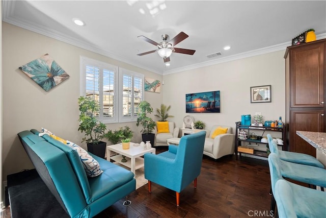 living area with ceiling fan, ornamental molding, dark wood finished floors, and visible vents