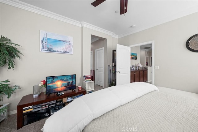 carpeted bedroom featuring ornamental molding, ceiling fan, and baseboards