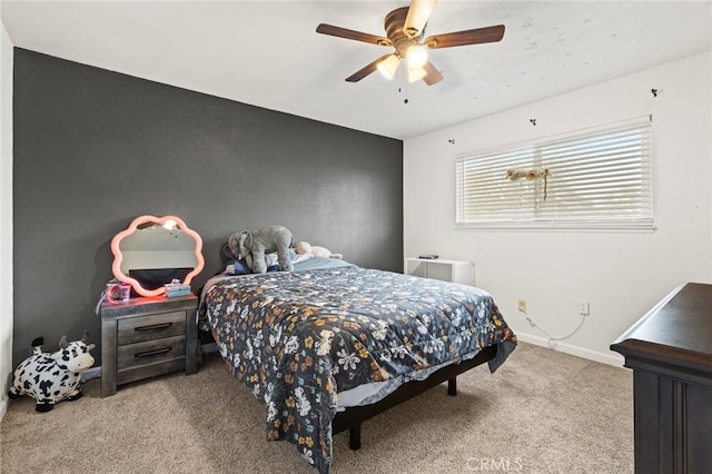 bedroom featuring light colored carpet, ceiling fan, and baseboards