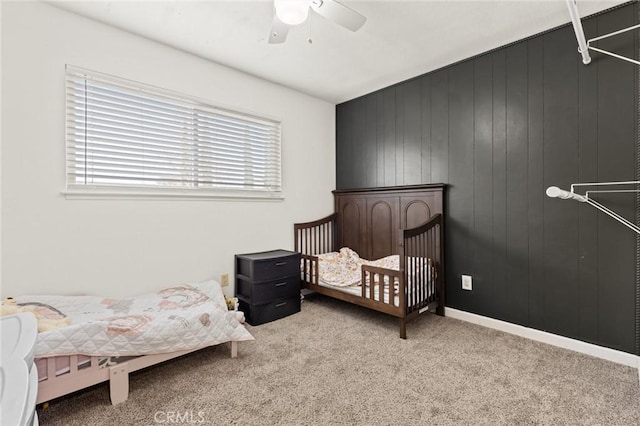 bedroom featuring ceiling fan, baseboards, and light colored carpet