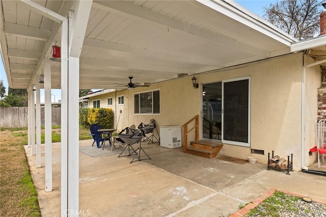 view of patio featuring a ceiling fan, entry steps, and fence